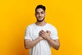 Smiling arab guy holding palms on chest Royalty Free Stock Photo