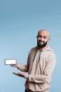 Smiling arab man showing smartphone