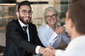 Smiling multiracial business partners handshake closing deal Royalty Free Stock Photo