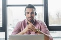 Smiling arabian businessman in headset having Royalty Free Stock Photo