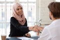 Smiling arabian female hr manager shaking hands with job applicant. Royalty Free Stock Photo