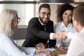 Smiling Arabian male employee handshake colleague at meeting Royalty Free Stock Photo