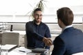 Smiling Arabic businessman handshake male partner at office meeting Royalty Free Stock Photo