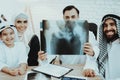 Smiling Arabic Family and Doctor Holding XRay Film Royalty Free Stock Photo