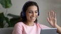 Smiling arabic woman in headphones talk using pad Royalty Free Stock Photo