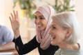 Smiling Arabic woman participate in team meeting in office Royalty Free Stock Photo