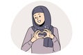 Smiling Arabic woman show heart gesture