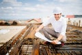 architect engineer on construction site, reading blueprints and coordinating workers Royalty Free Stock Photo