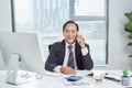 Smiling asian businessman calling someone in office Royalty Free Stock Photo