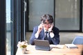 Smiling businessman working with computer tablet and talking on mobile phone. Royalty Free Stock Photo