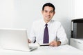 Smiling Asian businessman working in the office Royalty Free Stock Photo