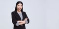 Smiling Asian businesswoman customer support phone operator isolated over gray background. call center and customer service Royalty Free Stock Photo