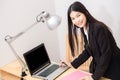 Smiling asian businesswoman with laptop computer posting in whit Royalty Free Stock Photo