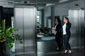 Asian businesswoman pushing button of elevator Royalty Free Stock Photo