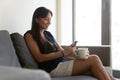 Smiling Asian employee relax in office having pleasant cellphone talk Royalty Free Stock Photo