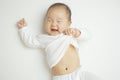 Smiling Asian Chinese baby pulling her shirt playfully Royalty Free Stock Photo