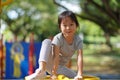 Smiling asian chinese girl climbed to the top of playground obstacles Royalty Free Stock Photo