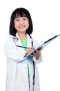 Smiling Asian Chinese Little Doctor Writting On Clip Board Royalty Free Stock Photo