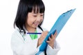 Smiling Asian Chinese Little Doctor Writting On Clip Board Royalty Free Stock Photo