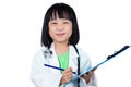 Smiling Asian Chinese Little Doctor Writting On Clip Board Royalty Free Stock Photo