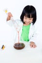 Smiling Asian Chinese Little Girl Examining Test Tube With Uniform Royalty Free Stock Photo