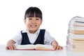 Smiling Asian Chinese little girl wearing school uniform studying Royalty Free Stock Photo