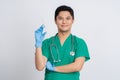 Smiling Asian doctor wearing blue gloves and mask with syringe..He was wearing a uniform on an isolated background Royalty Free Stock Photo