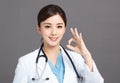Smiling asian female doctor hand with ok sign Royalty Free Stock Photo
