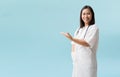 Smiling asian female doctor medical professional holding something in empty hand, Royalty Free Stock Photo