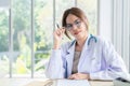 Smiling asian female doctor in the office , Portrait of beautiful mature woman doctor is committed to treating patients. healtcare