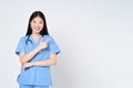 Smiling asian female doctor pointing with hand on copy space isolated on white background Royalty Free Stock Photo