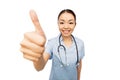 Smiling asian female doctor showing thumbs up Royalty Free Stock Photo