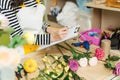 Smiling asian female florist making notes at flower shop counter Royalty Free Stock Photo