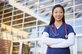 Smiling Asian female healthcare worker with arms crossed Royalty Free Stock Photo