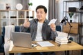 Smiling asian freelancer playing with paper plane Royalty Free Stock Photo