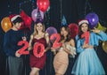 Smiling asian friends having fun celebrating on Christmas and New Year Party holding red shiny paper numeral 2021 Royalty Free Stock Photo