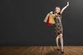 Smiling asian girl with black dress carrying shopping bags Royalty Free Stock Photo