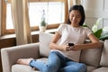 Smiling Asian girl browse internet on modern smartphone Royalty Free Stock Photo