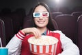 smiling asian girl in 3d glasses with big basket of popcorn watching movie Royalty Free Stock Photo