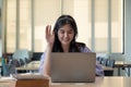 Smiling Asian girl in headphones have video call distant class with teacher using laptop, happy small child wave