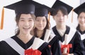 Smiling asian girl student  graduate and classmates standing with diplomas in hands Royalty Free Stock Photo