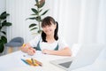 Smiling Asian girl studying online with Zoom program at home Royalty Free Stock Photo