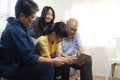 Smiling Asian grandparents on couch with granddaughter looking at tablet. happy three generation family spending time together at Royalty Free Stock Photo