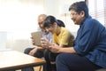 Smiling Asian grandparents on couch with granddaughter looking at tablet. happy three generation family spending time together at Royalty Free Stock Photo