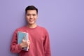 Smiling Asian guy with book in hands enjoy education and university, posing Royalty Free Stock Photo