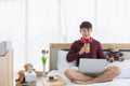 Man using laptop and drinking orange juice Royalty Free Stock Photo