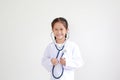 Smiling asian little child girl in doctor uniform with stethoscope isolated on white backgorund Royalty Free Stock Photo