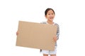 Smiling asian little girl holding empty brown big board for media banner isolated on white background with copy space Royalty Free Stock Photo