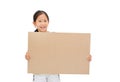 Smiling asian little girl holding empty brown big board for media banner isolated on white background with copy space Royalty Free Stock Photo