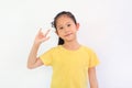Smiling Asian little girl showing finger I love you symbol sign language isolated on white background Royalty Free Stock Photo